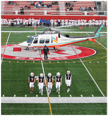 A group of football players celebrating a touchdown. Description generated by AI