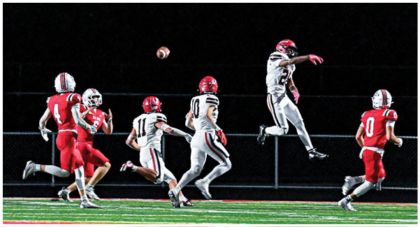 A football game is taking place on a field with players wearing blue and white uniforms. Description generated by AI