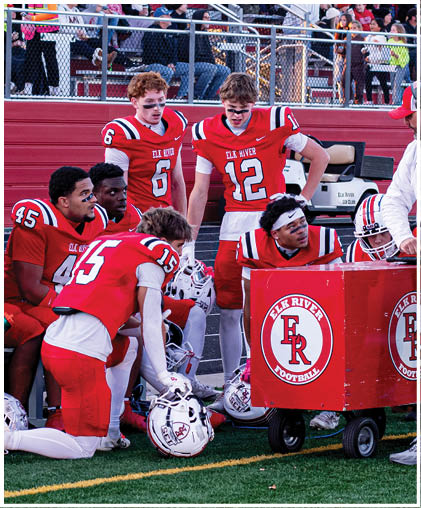 A group of football players celebrating a touchdown. Description generated by AI