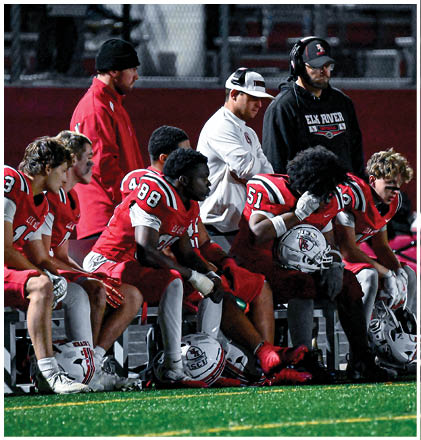 A group of football players celebrating a touchdown. Description generated by AI