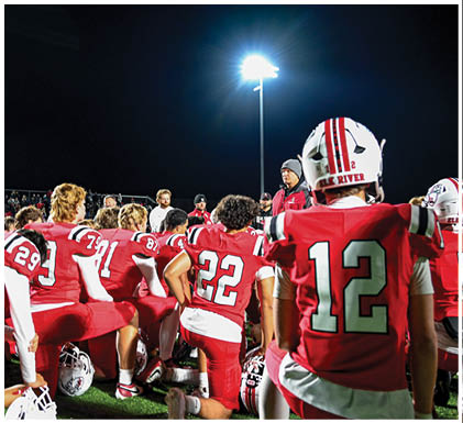 A group of football players celebrating a touchdown. Description generated by AI