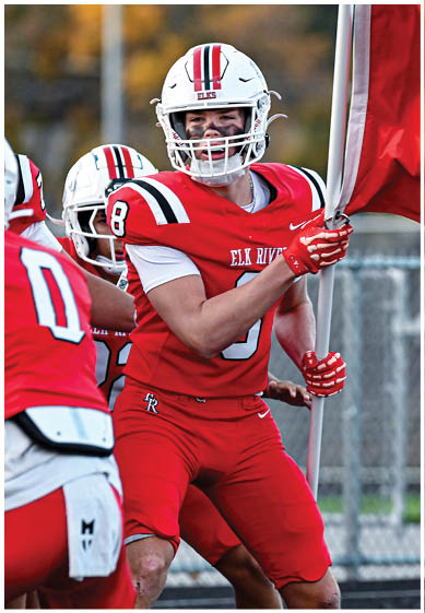 A football player wearing a blue and red jersey. Description generated by AI
