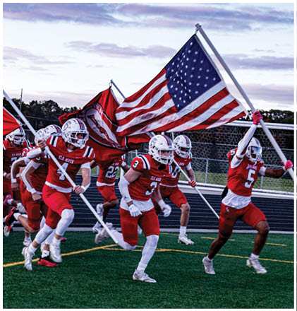 A group of football players celebrating a touchdown. Description generated by AI