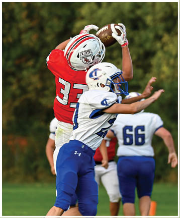 A football player running on the field. Description generated by AI