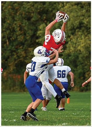 A football player running on the field. Description generated by AI