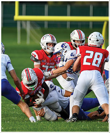 A football player running on the field. Description generated by AI