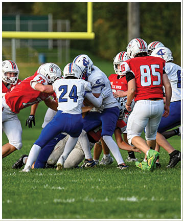 A football player running on the field. Description generated by AI