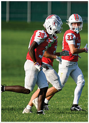 A football player running on the field. Description generated by AI