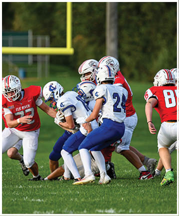 A football player running on the field. Description generated by AI