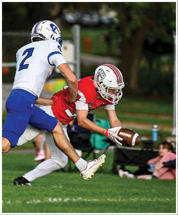 A football player running on the field. Description generated by AI
