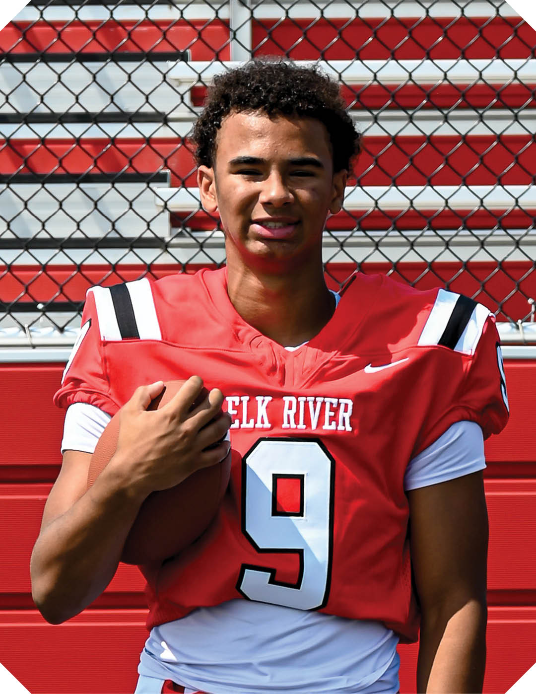A young man wearing a black and white jersey with the word Vista on it stands on a field. AI generated content