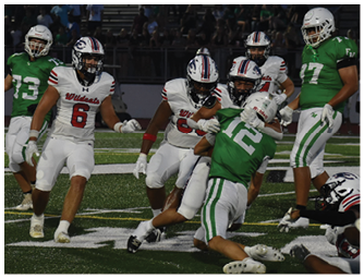 Several people in football uniforms are actively engaged in a play on a field, with some players in white uniforms and others in green uniforms. Description generated by AI