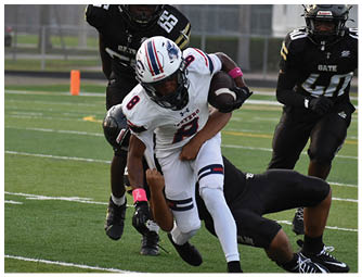 A group of people in football uniforms are playing on a field with one person in white running with the ball while others in black attempt to tackle. Description generated by AI