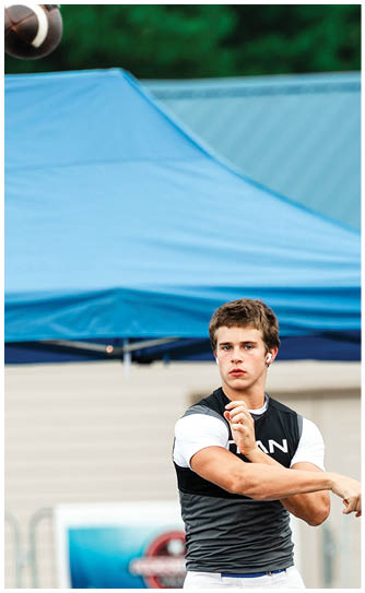 A football player catching a ball. Description generated by AI