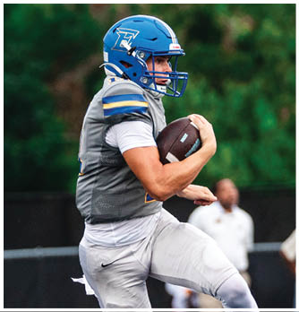 A football player catching a ball. Description generated by AI