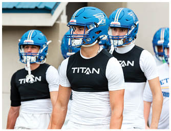 A group of football players on a field. Description generated by AI
