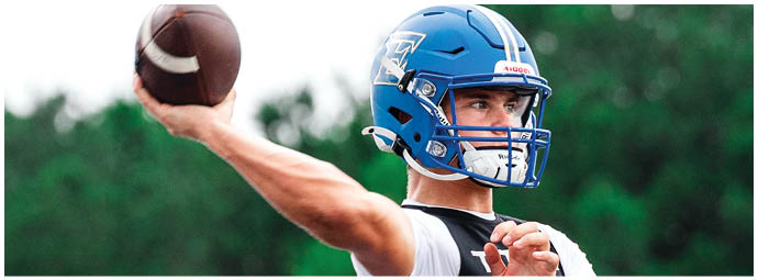 A football player wearing a blue and white uniform. Description generated by AI