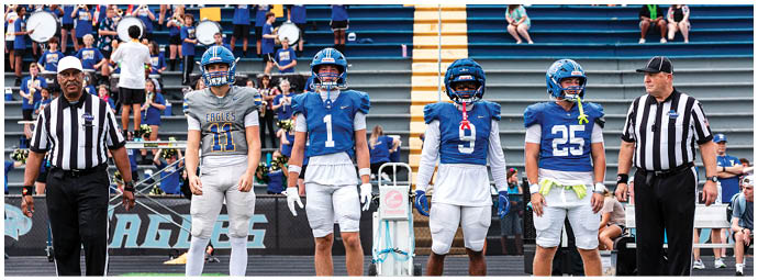 A football player wearing a blue and white uniform. Description generated by AI