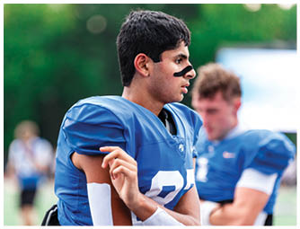 A group of football players on a field. Description generated by AI