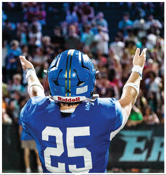 A football player catching a ball. Description generated by AI