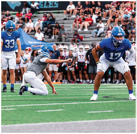 A group of football players on a field. Description generated by AI