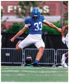 A football player catching a ball. Description generated by AI