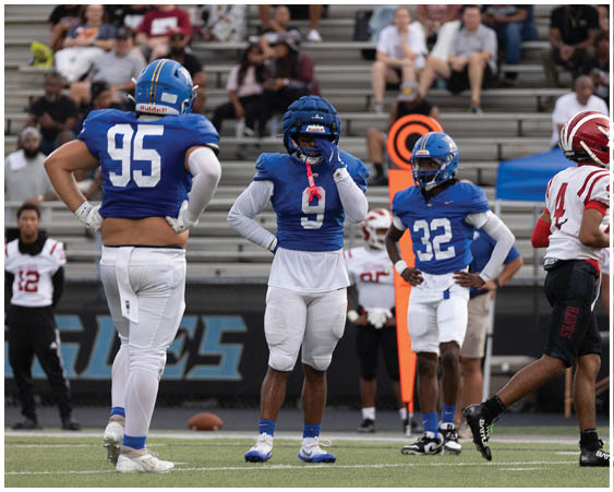 A football player wearing a blue and white uniform. Description generated by AI