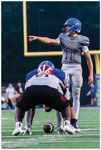A football game is being played on a field. Description generated by AI