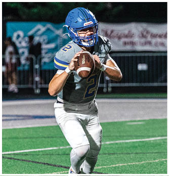 A football player catching a ball. Description generated by AI