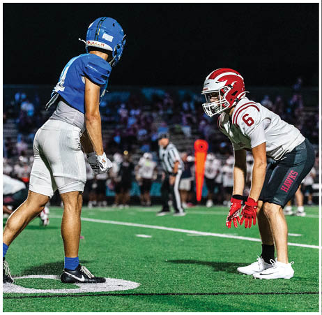 A group of football players on a field. Description generated by AI