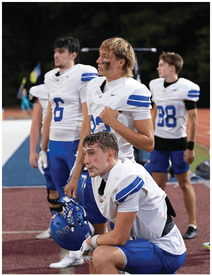 A football player wearing a blue jersey with the number 58 on it. Description generated by AI