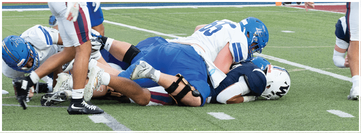 A football player is sliding on the ground. Description generated by AI