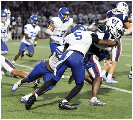 A football player running on the field. Description generated by AI