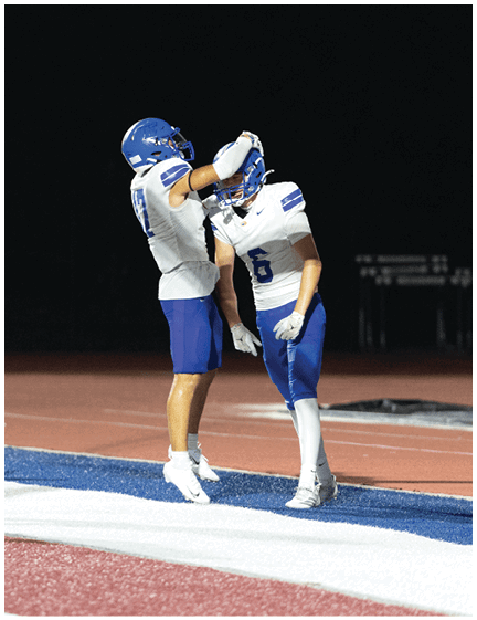 A football player wearing a blue jersey with the number 58 on it. Description generated by AI