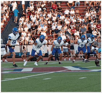 A football player running on the field. Description generated by AI