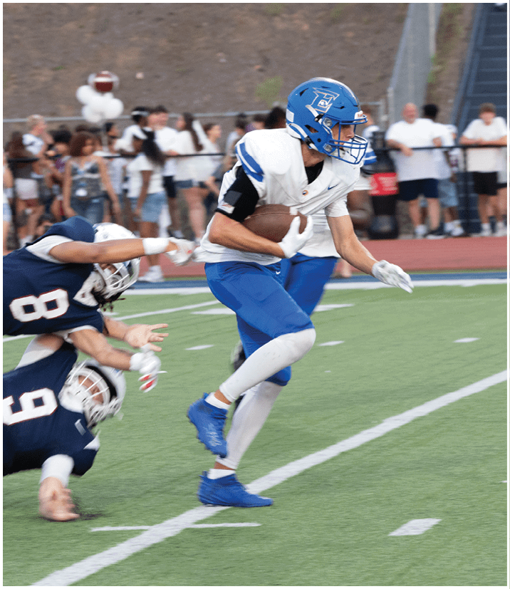 A group of football players wearing black and white uniforms. Description generated by AI
