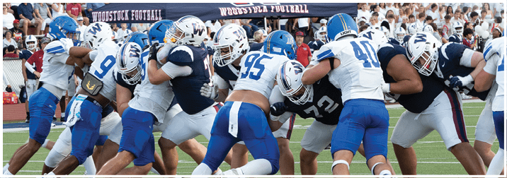 A group of football players on a field. Description generated by AI