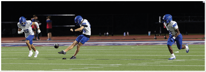 A group of football players on a field. Description generated by AI