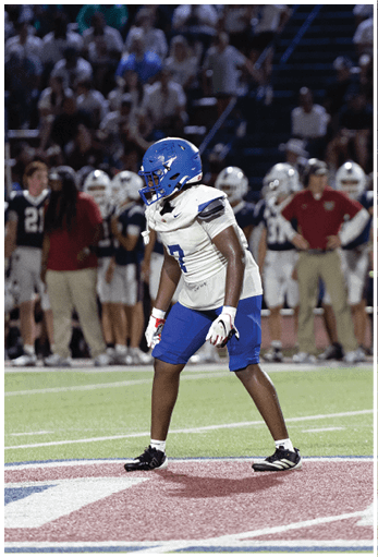 A football player running on the field. Description generated by AI