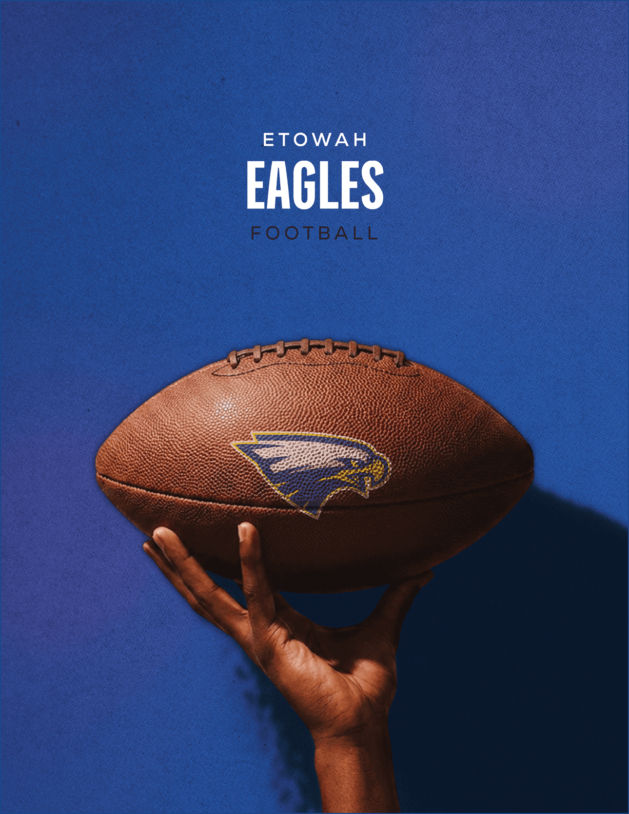 A football is being held by a person. Description generated by AI