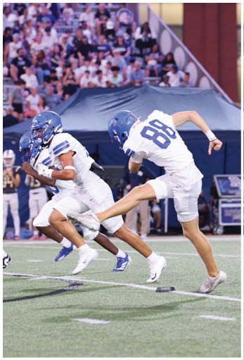 A football player running on the field. Description generated by AI