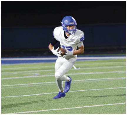 A football player running on the field. Description generated by AI