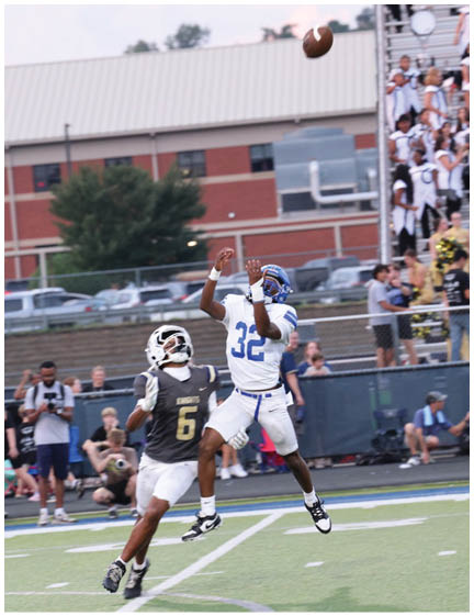 A football player wearing a blue jersey with the number 58 on it. Description generated by AI