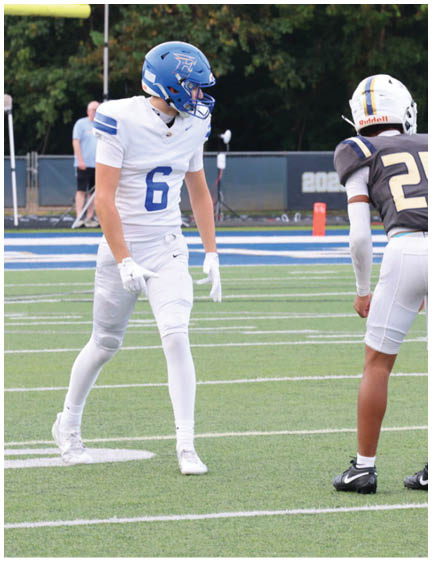 A football player wearing a blue jersey with the number 58 on it. Description generated by AI