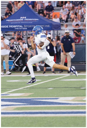 A football player running on the field. Description generated by AI