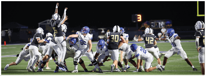 A football player is sliding on the ground. Description generated by AI