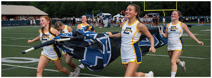 A football player wearing a blue and white uniform. Description generated by AI