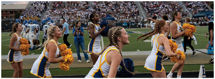 A football player wearing a blue and white uniform. Description generated by AI