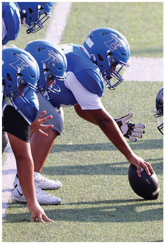 A football game is being played on a field. Description generated by AI