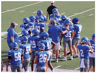 A group of football players on a field. Description generated by AI